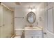 Clean bathroom boasts a glass-enclosed shower, white vanity, and mirrored medicine cabinet at 2700 Ocean Shore Blvd # 305, Ormond Beach, FL 32176