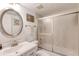 Clean bathroom with a well lit vanity, toilet, and shower with sliding glass doors at 2700 Ocean Shore Blvd # 305, Ormond Beach, FL 32176