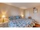 Comfortable bedroom features queen bed with patterned comforter, side tables and decor at 2700 Ocean Shore Blvd # 305, Ormond Beach, FL 32176