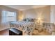 Comfortable bedroom features queen bed with patterned comforter, side tables and decor at 2700 Ocean Shore Blvd # 305, Ormond Beach, FL 32176