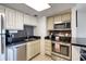 Modern kitchen with stainless steel appliances, dark countertops, and stylish backsplash at 2700 Ocean Shore Blvd # 305, Ormond Beach, FL 32176