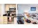Open kitchen featuring stainless steel appliances, dark countertops, and adjacent living space at 2700 Ocean Shore Blvd # 305, Ormond Beach, FL 32176