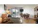 Bright living room boasts a comfortable sofa, table with seating and sliding door to the balcony at 2700 Ocean Shore Blvd # 305, Ormond Beach, FL 32176