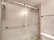 Modern shower with frosted glass doors and brushed nickel hardware in updated bathroom at 2700 Ocean Shore Blvd # 305, Ormond Beach, FL 32176
