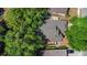 Aerial view of a home with a newer roof nestled among mature trees and well-kept lawns in a quiet neighborhood at 2859 Doe Run Trl, Orange City, FL 32763