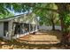 Private backyard features lush greenery and a patio, creating a serene and inviting outdoor oasis at 2859 Doe Run Trl, Orange City, FL 32763
