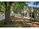 Inviting backyard features a patio with a lush shady tree, creating a peaceful and secluded outdoor retreat at 2859 Doe Run Trl, Orange City, FL 32763