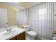 Cozy bathroom featuring a toilet, shower with patterned curtain, and a vanity with sink at 2859 Doe Run Trl, Orange City, FL 32763