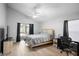 Cozy bedroom with slider, desk, and wood-look floors at 2859 Doe Run Trl, Orange City, FL 32763