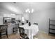 Combined kitchen and dining area featuring stainless steel appliances and modern lighting at 2859 Doe Run Trl, Orange City, FL 32763