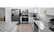 Modern kitchen featuring stainless steel appliances, granite counters, and white subway tile at 2859 Doe Run Trl, Orange City, FL 32763