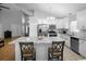 Spacious kitchen featuring stainless steel appliances, white cabinets, and marble island at 2859 Doe Run Trl, Orange City, FL 32763