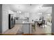 Airy kitchen with stainless steel appliances, white cabinets, and an island with marble countertop at 2859 Doe Run Trl, Orange City, FL 32763