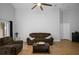 Inviting living room with ceiling fan, wood floors and cozy brown couches at 2859 Doe Run Trl, Orange City, FL 32763