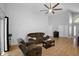 Inviting living room with ceiling fan, wood floors and cozy brown couches at 2859 Doe Run Trl, Orange City, FL 32763