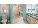 This bathroom features a glass shower, a white vanity, and lovely light-blue walls at 2967 S Atlantic Ave # 604, Daytona Beach, FL 32118