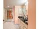 Bathroom featuring a double sink vanity, tiled floors, and a large mirror at 2967 S Atlantic Ave # 604, Daytona Beach, FL 32118