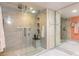 Modern bathroom features a glass shower with grey tiled walls and built-in shelving at 2967 S Atlantic Ave # 604, Daytona Beach, FL 32118