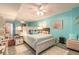 Bright bedroom features aqua walls, tiled floors, and a plush king-sized bed at 2967 S Atlantic Ave # 604, Daytona Beach, FL 32118