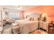 Bedroom featuring a large bed, nightstands, and ocean views from the window at 2967 S Atlantic Ave # 604, Daytona Beach, FL 32118