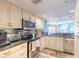 Bright kitchen with stainless steel appliances, granite countertops, and blue accent wall at 2967 S Atlantic Ave # 604, Daytona Beach, FL 32118