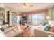 Bright living room featuring a ceiling fan, hardwood floors, and sliding glass doors to a balcony with ocean views at 2967 S Atlantic Ave # 604, Daytona Beach, FL 32118