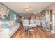 Spacious living room with hardwood floors, cream furniture, glass coffee table, and open access to the kitchen at 2967 S Atlantic Ave # 604, Daytona Beach, FL 32118