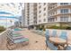 Bright, sunny pool area with lots of light blue lounge chairs surrounded by the high rise condos at 2967 S Atlantic Ave # 604, Daytona Beach, FL 32118