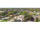 An aerial view showcases the neighborhood's homes, mature trees, and well-manicured lawns at 3021 Little Cypress Cv, Winter Park, FL 32792