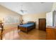 Bright bedroom with ceiling fan, wood laminate flooring, and plantation shutters at 3021 Little Cypress Cv, Winter Park, FL 32792
