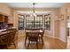 Charming dining area featuring a bay window with views of the landscaped yard at 3021 Little Cypress Cv, Winter Park, FL 32792