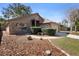 Single-story home with brick and siding exterior, complemented by a brick walkway and manicured shrubbery at 3021 Little Cypress Cv, Winter Park, FL 32792