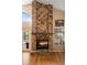 Stunning brick fireplace featuring vaulted ceilings, a decorative mantel, and a brick hearth at 3021 Little Cypress Cv, Winter Park, FL 32792