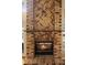 Elegant brick fireplace with herringbone pattern and wooden mantel, radiating warmth and charm at 3021 Little Cypress Cv, Winter Park, FL 32792