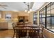Open kitchen and dining area with wood-look flooring, wood cabinets, and a large bay window at 3021 Little Cypress Cv, Winter Park, FL 32792