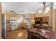 Spacious kitchen with wood-look flooring, light wood cabinets, and a dining area with a table and chairs at 3021 Little Cypress Cv, Winter Park, FL 32792