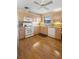 Functional kitchen featuring wood-look flooring, ample cabinet space, and white appliances at 3021 Little Cypress Cv, Winter Park, FL 32792