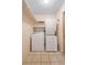 Convenient laundry area with a stacked washer and dryer, plus overhead shelving at 3021 Little Cypress Cv, Winter Park, FL 32792