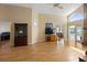 Spacious living room featuring laminate floors, arch window, high ceilings, and furniture at 3021 Little Cypress Cv, Winter Park, FL 32792