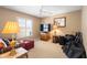 Cozy living room featuring neutral colors, a ceiling fan, and a large window offering natural light at 3021 Little Cypress Cv, Winter Park, FL 32792