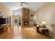 Inviting living room with vaulted ceilings, brick fireplace, and lots of natural light at 3021 Little Cypress Cv, Winter Park, FL 32792