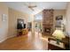 Bright living room with brick fireplace, vaulted ceiling, and a view of the backyard at 3021 Little Cypress Cv, Winter Park, FL 32792