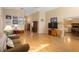 Open living room with hardwood floors, featuring a large television and comfortable seating at 3021 Little Cypress Cv, Winter Park, FL 32792