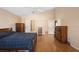 Large main bedroom with wood laminate floors, ceiling fan, walk in closet, and attached bathroom at 3021 Little Cypress Cv, Winter Park, FL 32792