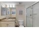 A well-lit bathroom featuring a glass shower, granite countertop, and vanity at 3315 S Atlantic Ave # 705, Daytona Beach, FL 32118