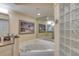 Bathroom includes granite countertops, a large soaking tub, and a glass block shower at 3315 S Atlantic Ave # 705, Daytona Beach, FL 32118