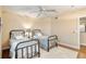 Comfortable bedroom featuring two twin beds, a ceiling fan, and hardwood floors creating a cozy and inviting space at 3315 S Atlantic Ave # 705, Daytona Beach, FL 32118
