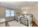 Comfortable bedroom with two twin beds, ceiling fan, and a window with plantation shutters offering ample natural light at 3315 S Atlantic Ave # 705, Daytona Beach, FL 32118