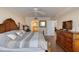 Cozy bedroom with access to ensuite bathroom, television, and wooden furniture at 3315 S Atlantic Ave # 705, Daytona Beach, FL 32118