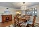 Well-lit dining room with a round wooden table, seating for six, decorative mirror, and an open view to the kitchen at 3315 S Atlantic Ave # 705, Daytona Beach, FL 32118